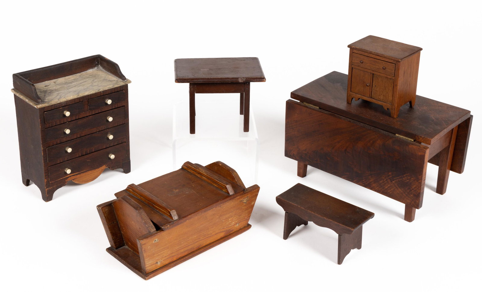AMERICAN MINIATURE DOLL FURNITURE, LOT OF SIX: AMERICAN MINIATURE DOLL FURNITURE, LOT OF SIX,including a paint-decorated chest of drawers with likely original knobs featuring a smoke-decorated top.19th century.Chest of drawers 8" HOA. Provenance: 