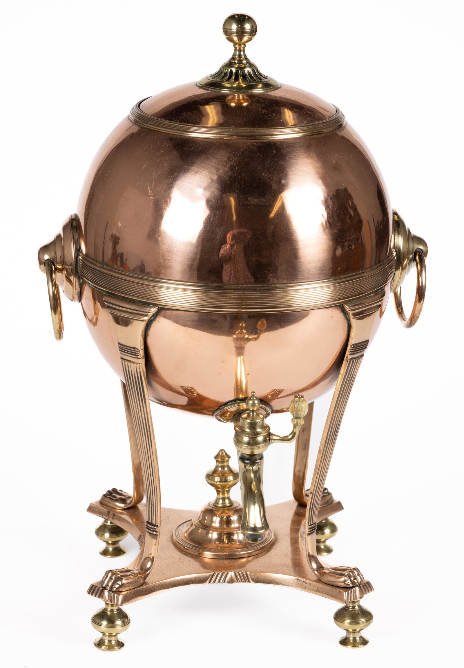 ENGLISH COPPER AND BRASS SAMAVAR / HOT WATER KETTLE: ENGLISH COPPER AND BRASS SAMAVAR / HOT WATER KETTLE,globular-form body with brass ribbed medial banding, double handles, raised on four ribbed legs terminating in figural paw feet, contoured base supp