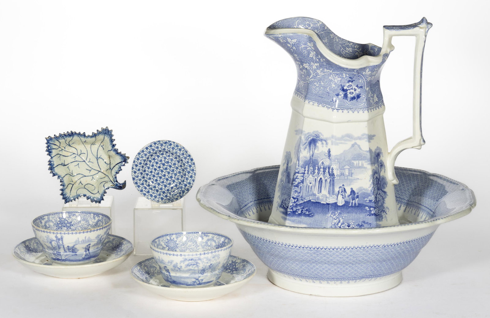 ENGLISH STAFFORDSHIRE BLUE-DECORATED CERAMIC ARTICLES, LOT OF EIGHT: ENGLISH STAFFORDSHIRE BLUE-DECORATED CERAMIC ARTICLES, LOT OF EIGHT,comprising a leaf-form pickle dish with hand-painted decorations, and seven examples with transfer-printed scenes including a wash b
