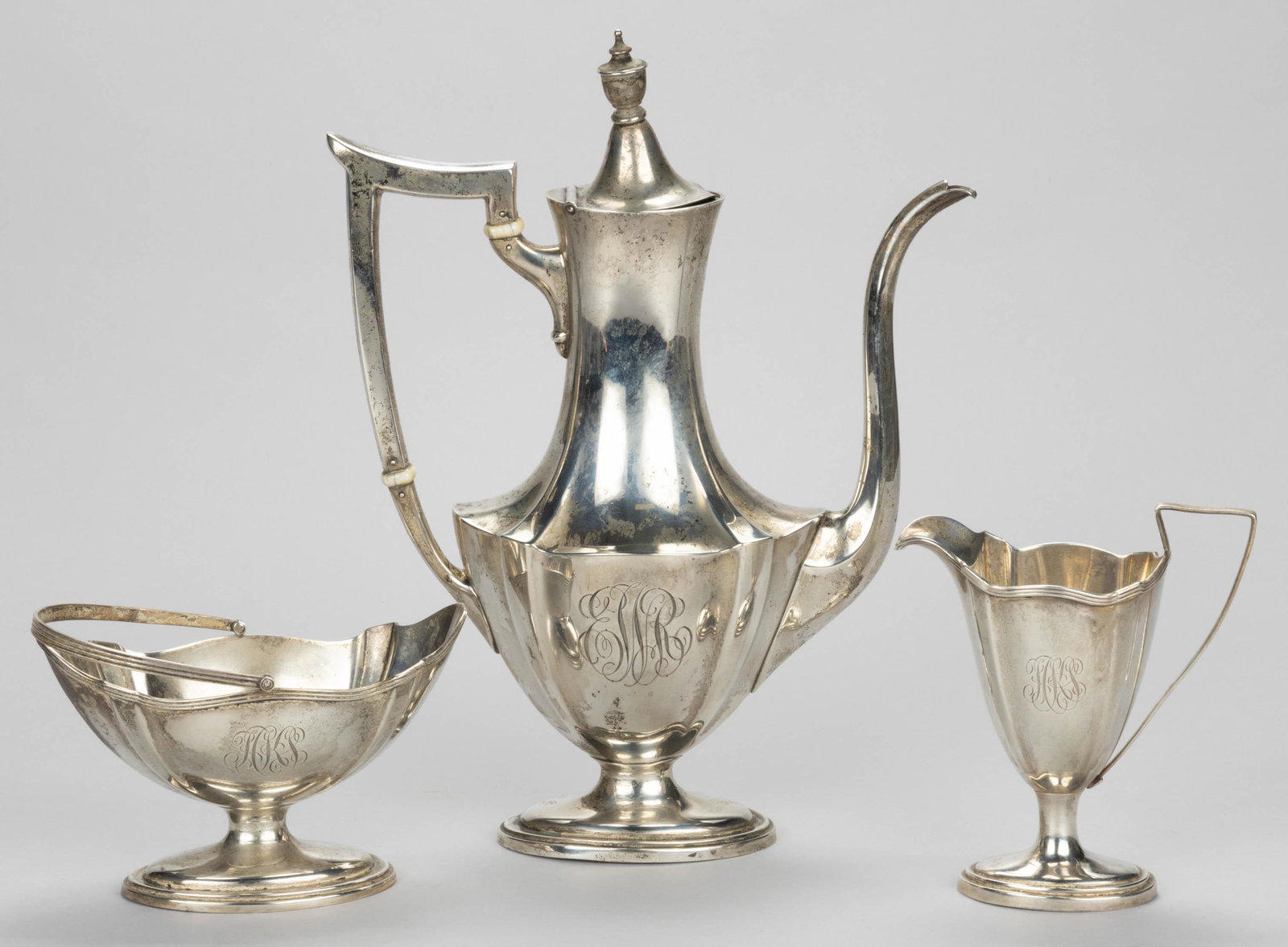GORHAM "PLYMOUTH" STERLING SILVER THREE-PIECE BREAKFAST / INDIVIDUAL COFFEE SERVICE: GORHAM "PLYMOUTH" STERLING SILVER THREE-PIECE BREAKFAST / INDIVIDUAL COFFEE SERVICE,comprising a small coffee pot with bone insulators, engraved "EWR" monogram, and a 1916 date mark, and a small cream