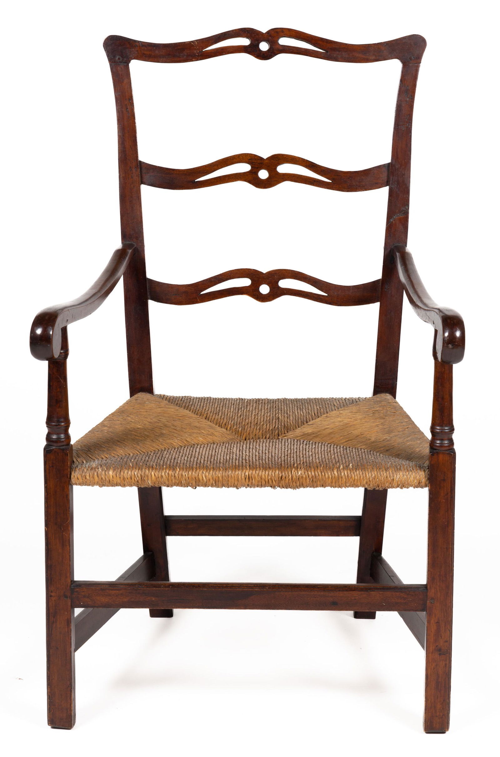 COUNTRY CHIPPENDALE RIBBON-BACK MAHOGANY ARM CHAIR: COUNTRY CHIPPENDALE RIBBON-BACK MAHOGANY ARM CHAIR,featuring shaped arm rails, raised on square legs joined by a box stretcher, old rush-seat, dated on backside of chair "1806". Retains an old surface