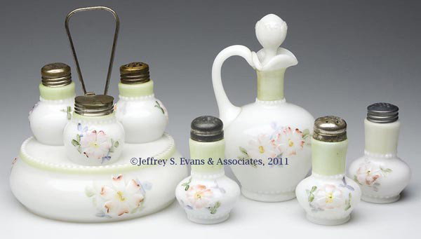 COREOPSIS CONDIMENT ARTICLES, LOT OF FIVE: COREOPSIS CONDIMENT ARTICLES, LOT OF FIVE, opaque white/milk glass with polychrome decoration, each with pale green band, comprising a set with salt and pepper shakers and mustard pot in stand; with a