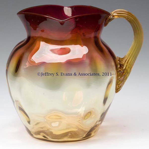 AMBERINA INVERTED THUMBPRINT PITCHER: AMBERINA INVERTED THUMBPRINT PITCHER, square rim, amber applied reeded handle, and polished pontil mark. W. L. Libbey & Sons and others. Late 19th/early 20th century. 6 1/4" HOA, 5" DOA.