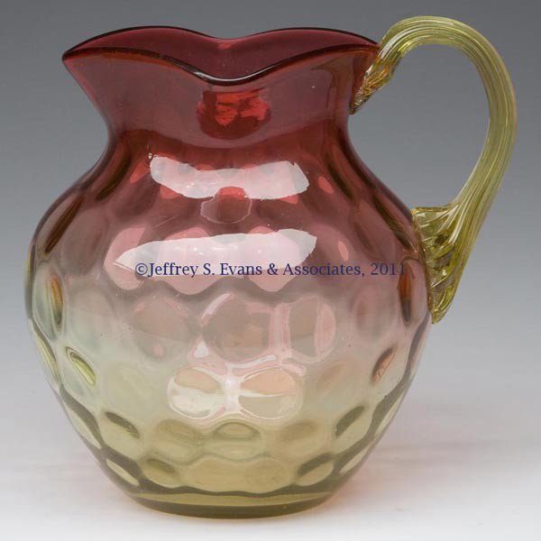 AMBERINA SPOT-OPTIC / POLKA DOT PITCHER: AMBERINA SPOT-OPTIC / POLKA DOT PITCHER, square rim, amber applied reeded handle and polished pontil mark. Hobbs, Brockunier & Co. and others. Fourth quarter 19th century. 5 3/4" HOA, 4 3/4" DOA.