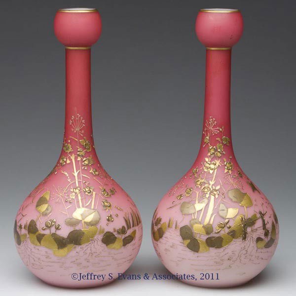 WEBB CASED PEACHBLOW-STYLE PAIR OF VASES: WEBB CASED PEACHBLOW-STYLE PAIR OF VASES, delicate two-tone gilt decoration of pond lilies, cattails, flowers and birds, bases polished to casing. Probably Thomas Webb & Sons. Fourth quarter 19th cent