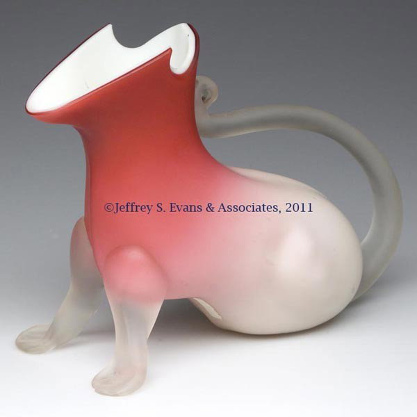 RARE SATIN GLASS ANIMAL-FORM JUG: RARE SATIN GLASS ANIMAL-FORM JUG, shaded rose, factory cut and polished rim, applied front feet and tail-like handle. Possibly Stevens and Williams. Fourth quarter 19th century. 6 1/2" H, 8 1/4" L. Pr