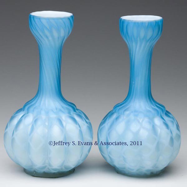 DIAMOND QUILTED AIR-TRAP MOTHER-OF-PEARL SATIN GLA: DIAMOND QUILTED AIR-TRAP MOTHER-OF-PEARL SATIN GLASS PAIR OF VASES, shaded blue, each with a melon body, plain rim and rough pontil mark. Fourth quarter 19th century. 7" H. Provenance: From an old Pen