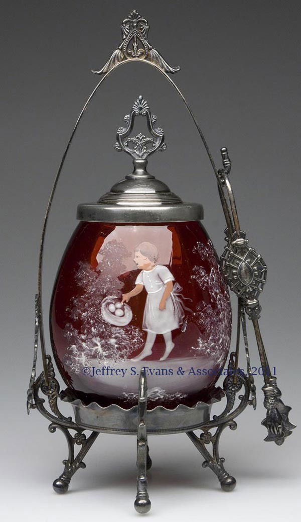 RIB-OPTIC PICKLE CASTER: RIB-OPTIC PICKLE CASTER, ruby, with Mary Gregory (so called) decoration of a child pointing to a bird's nest, roughed pontil mark, fitted in a Wm. Rogers Manufacturing Co. quadruple-plate frame, marke