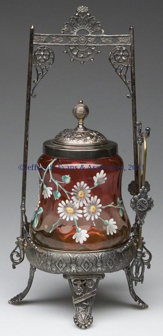 INVERTED THUMBPRINT PICKLE CASTER: INVERTED THUMBPRINT PICKLE CASTER, amberina with polychrome floral decoration, polished table ring, fitted in a James W. Tufts triple-plate frame, marked "3375", with cover and tongs. Rim of jar polis