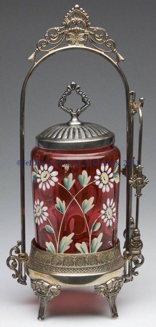 INVERTED THUMBPRINT PICKLE CASTER: INVERTED THUMBPRINT PICKLE CASTER, deep cranberry with full-round polychrome decoration, fitted in a James W. Tufts triple-plate frame, marked "2362", with cover and tongs. Jar with polishing to rim,