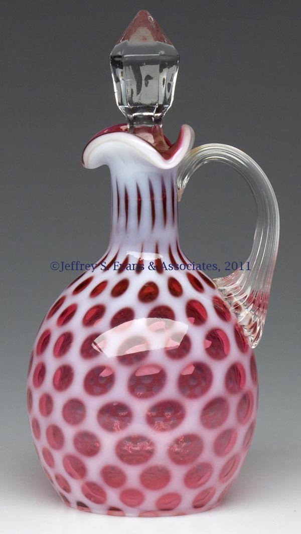 HONEYCOMB / WINDOWS CRUET: HONEYCOMB / WINDOWS CRUET, cranberry opalescent, colorless ribbed handle, slightly ill-fitting appropriate stopper. Fenton Glass Co. for L. G. Wright. Second half 20th century. 7" HOA. Provenance: Fro
