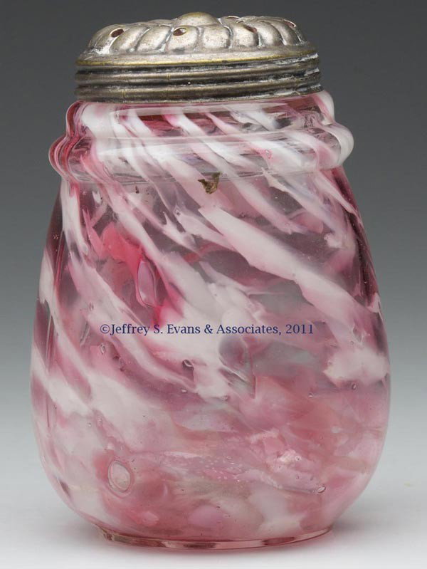 RING NECK SUGAR SHAKER: RING NECK SUGAR SHAKER, colorless with cranberry and opal spatter, period lid. Northwood Glass Co. Fourth quarter 19th century. 4 1/2" HOA. Provenance: Estate collection of Dorothy and Marshall Jenkin