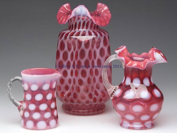 FENTON ARTICLES, LOT OF THREE: FENTON ARTICLES, LOT OF THREE, cranberry opalescent, comprising a Coindot Pinch Vase, with tooled ruffled rim, embossed under base, with original papers and box, and two Coinspot pitchers, one with to
