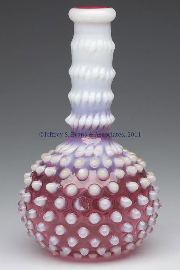 HOBBS' NO. 323 DEW DROP / HOBBS' HOBNAIL BARBER BO: HOBBS' NO. 323 DEW DROP / HOBBS' HOBNAIL BARBER BOTTLE, Ruby opalescent/cranberry opalescent, polished pontil mark. Hobbs, Brockunier & Co. Fourth quarter 19th century. 7" H, 4" DOA. Provenance: From 