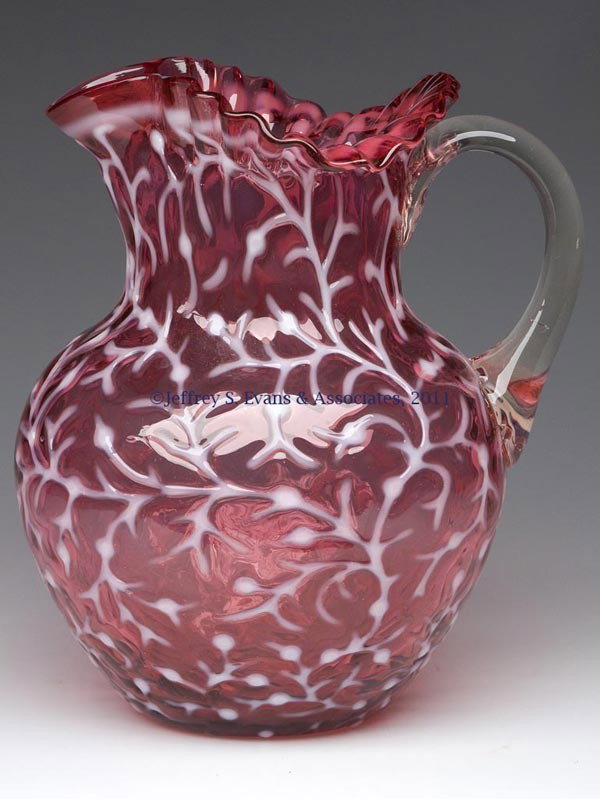 SEAWEED / CORAL REEF WATER PITCHER: SEAWEED / CORAL REEF WATER PITCHER, cranberry opalescent, triangular-crimped rim, colorless applied handle with pressed fan design to upper terminal, polished pontil mark. Hobbs, Brockunier & Co. and 