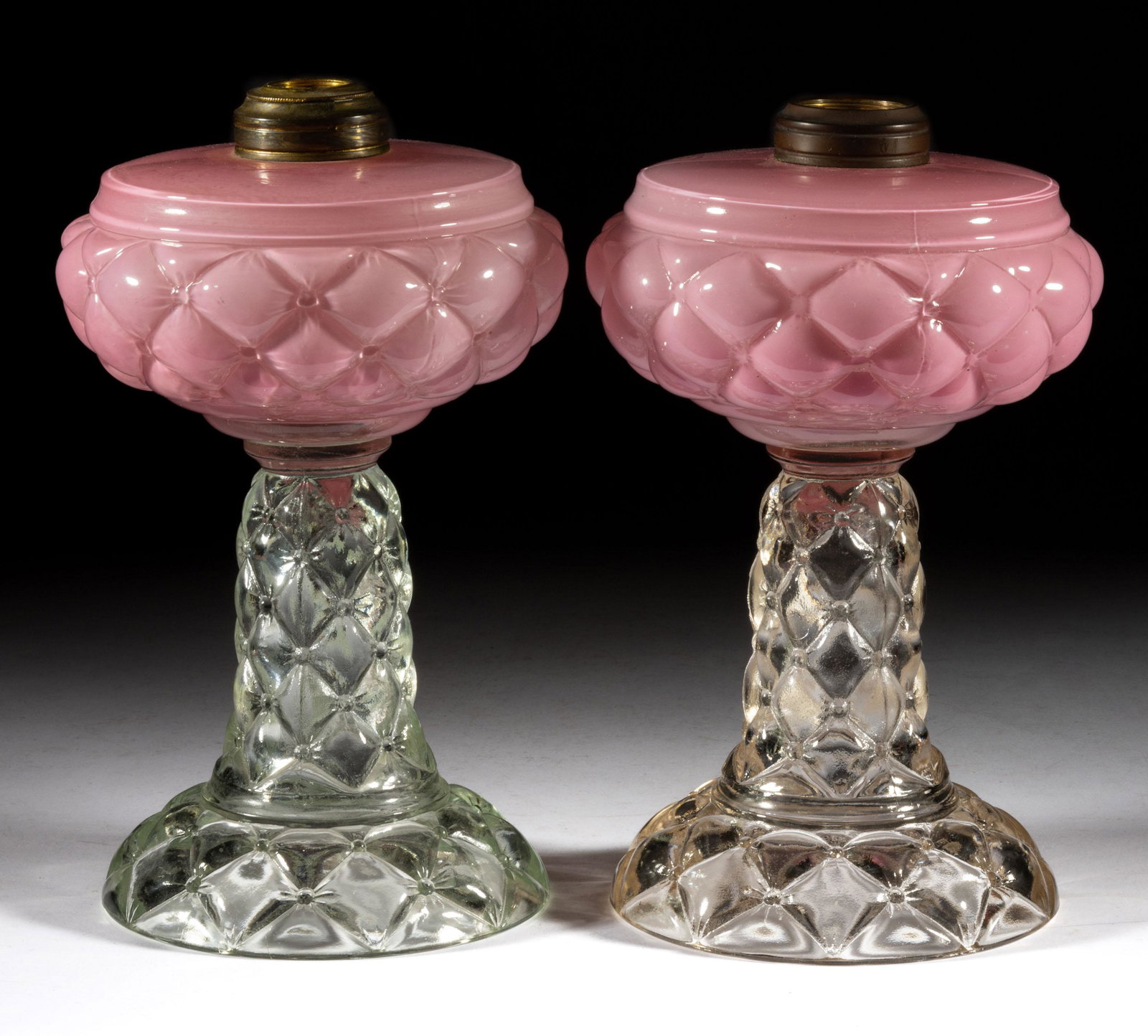 QUILT / FLORETTE PAIR OF KEROSENE STAND LAMPS: QUILT / FLORETTE PAIR OF KEROSENE STAND LAMPS, cased pink fonts, colorless bases, each having a No. 2 Taplin-Brown collar with one fitted with an adapter. Consolidated Lamp & Glass Co. Circa 1894.