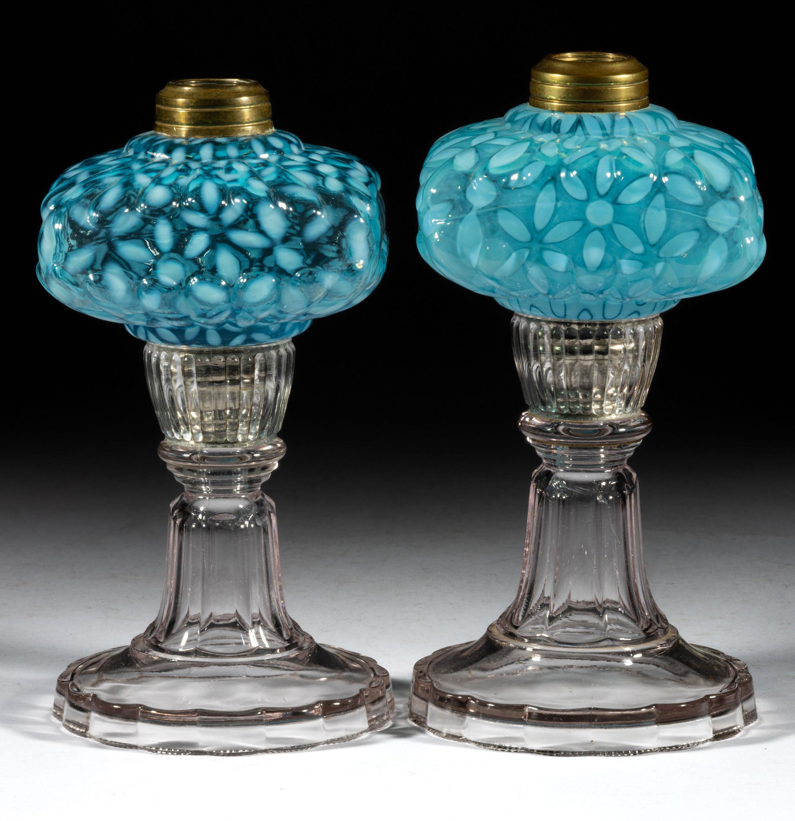 HOBBS NO. 341 / SNOWFLAKE KEROSENE STAND LAMPS, LOT OF TWO: HOBBS NO. 341 / SNOWFLAKE KEROSENE STAND LAMPS, LOT OF TWO, Sapphire/blue opalescent font, colorless base, each having a metal screw connector with original glass sleeve, No. 1 Taplin-Brown collar. Ho