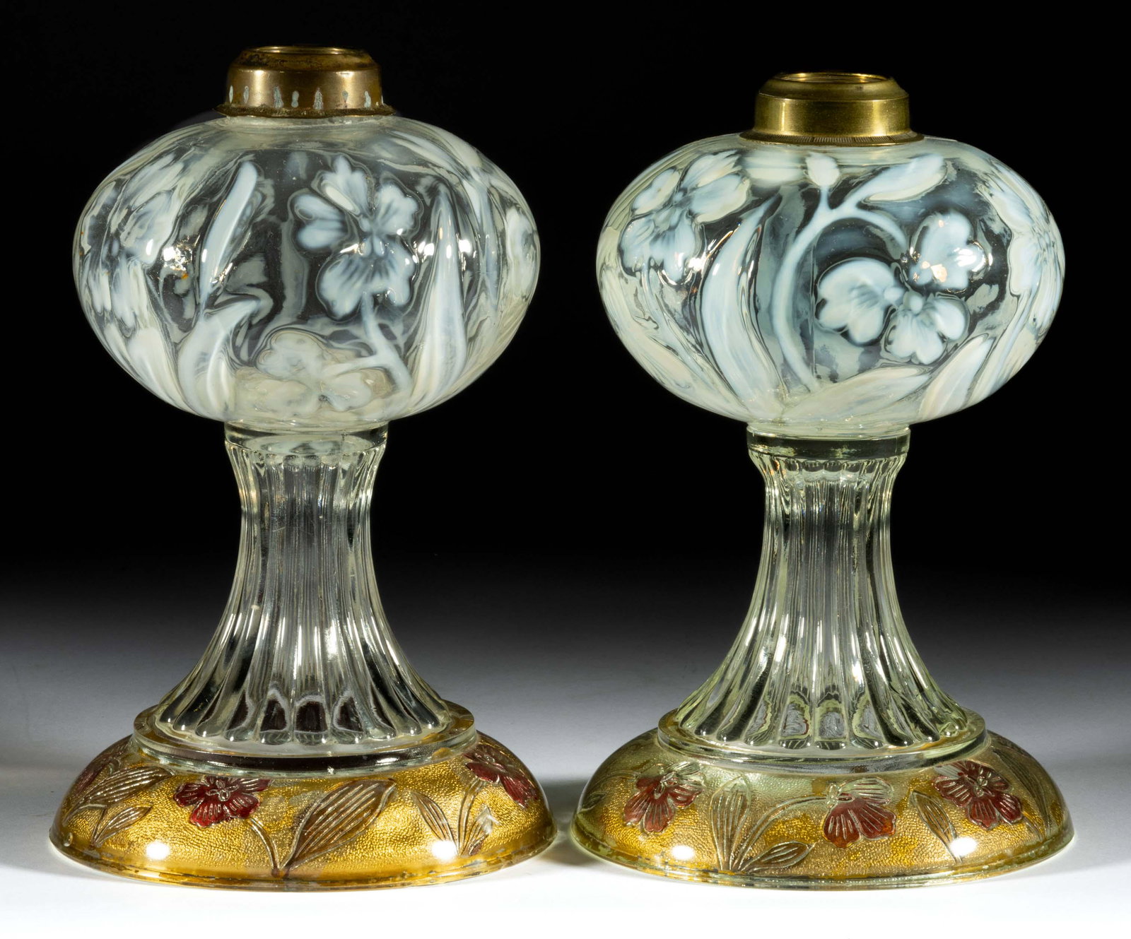 PRIMROSE PAIR OF KEROSENE STAND LAMPS,: PRIMROSE PAIR OF KEROSENE STAND LAMPS, colorless opalescent fonts, colorless bases with have Goofus decoration to the underside. Each having a period Ebling collar. Fourth quarter 19th century. 8 7/8&