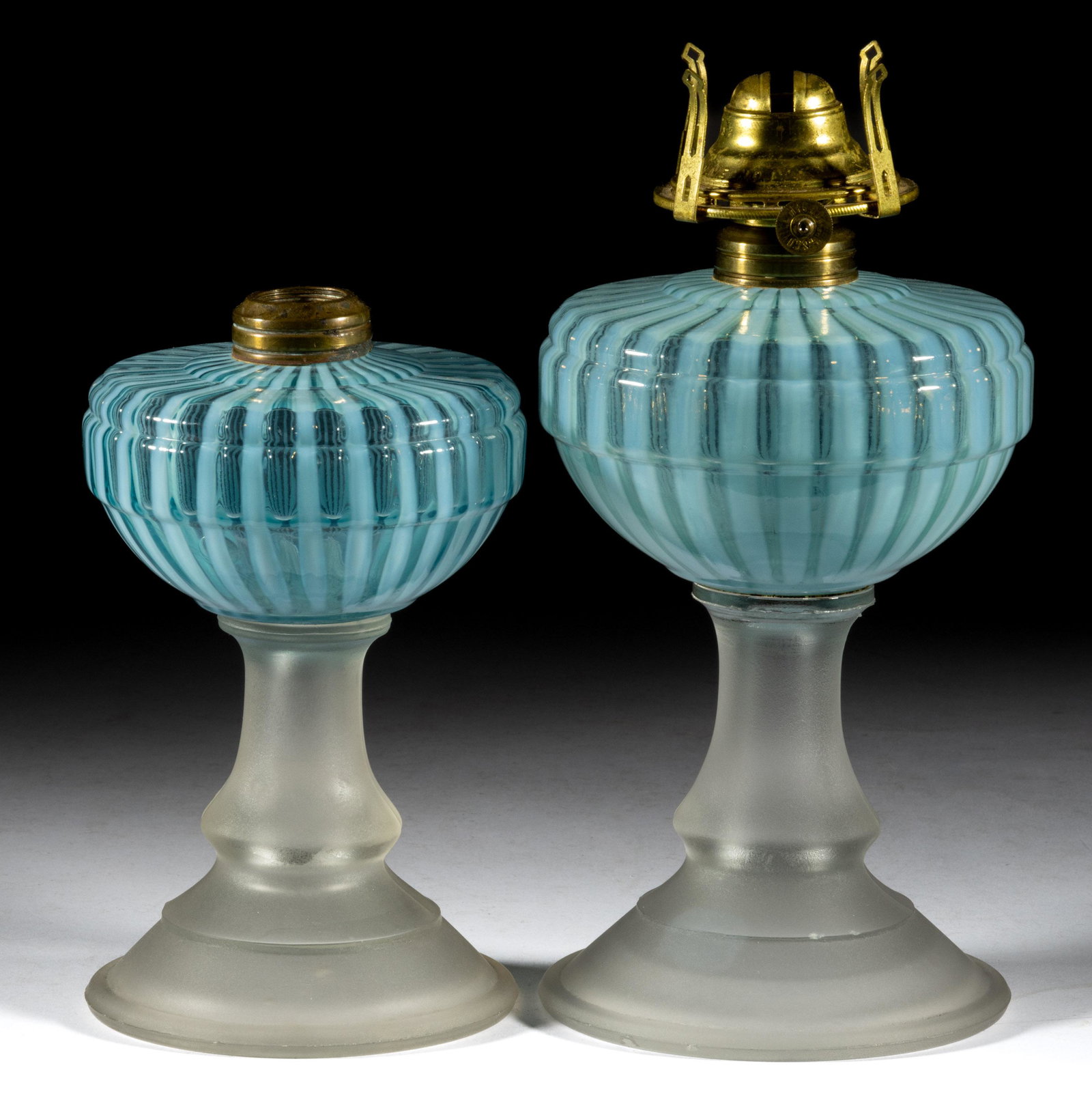 ALVA KEROSENE STAND LAMPS, LOT OF TWO: ALVA KEROSENE STAND LAMPS, LOT OF TWO, blue opalescent fonts, frosted colorless bases, each having a period No. 1 Taplin-Brown collars. One fitted with a period No. 1 slip burner. Fourth quarter 19th 