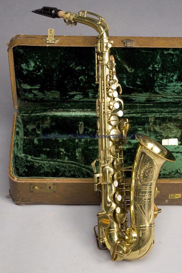BUESCHER ARISTOCRAT SAXOPHONE: BUESCHER ARISTOCRAT SAXOPHONE, original fitted case, numbered "329471 / 140." Mid 20th century. 25" H.