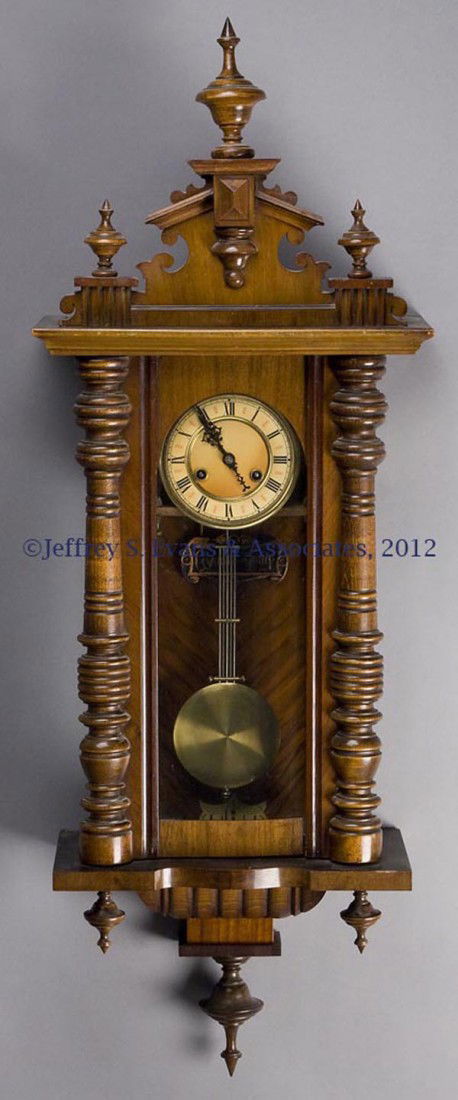 VICTORIAN VIENNA REGULATOR WALNUT WALL CLOCK: VICTORIAN VIENNA REGULATOR WALNUT WALL CLOCK, ornate crest and pendant drop, time and striking "Cymbol-Gong", original pendulum and key. Late 19th/early 20th century. 44" HOA, 16" W. Provenance: Estat