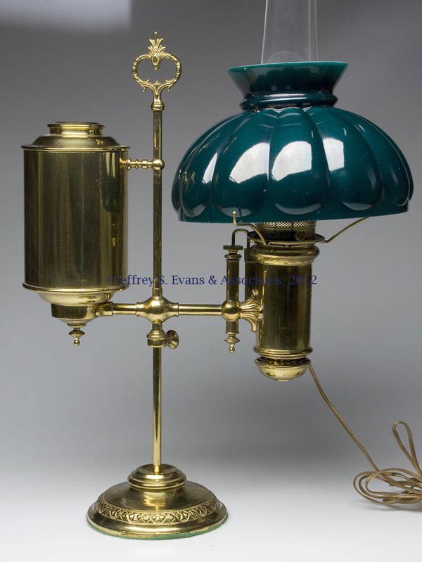 THE MILLER LAMP CO. SINGLE-ARM STUDENT LAMP: THE MILLER LAMP CO. SINGLE-ARM STUDENT LAMP, brass and brass-plated metal, vertical tank on adjustable central shaft, weighted foot, electrified burner, impressed patent date to wick raiser and to top