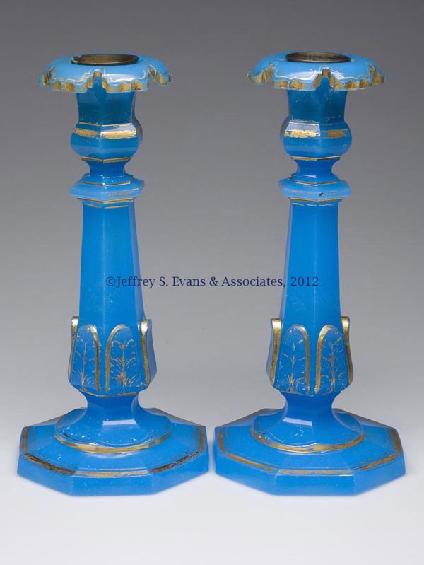 PAIR OF CONTINENTAL OPALINE CANDLESTICKS: PAIR OF CONTINENTAL OPALINE CANDLESTICKS, blue with gilt decorations, each of hexagonal columnar form with inset brass nozzle. Second half 19th century. 10 1/2" H. Provenance: Estate collection of Dor