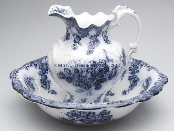 JOHNSON BROS. FLOW BLUE EWER AND BASIN: JOHNSON BROS. FLOW BLUE EWER AND BASIN, blue and white, base of each piece with manufacturer's mark, with "VIENNA" above and "ENGLAND" below. Hanley and Tunstall, England. Early 20th century. 11 1/2"