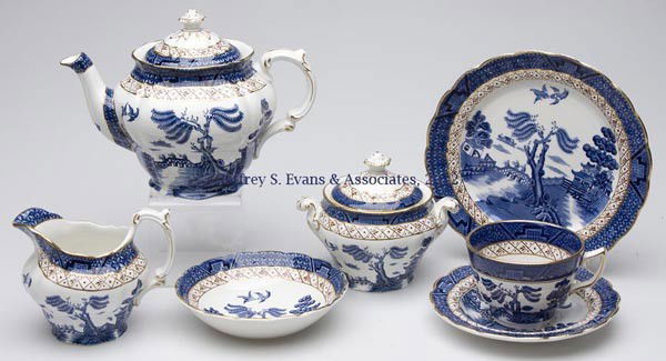 BOOTHS' "REAL OLD WILLOW" DESSERT SET: BOOTHS' "REAL OLD WILLOW" DESSERT SET, blue and white with gilt decoration, 35 pieces, comprising a teapot, sugar and creamer, and eight each 7 1/4" plates, 5 1/4" berry dishes, and standard cup and s