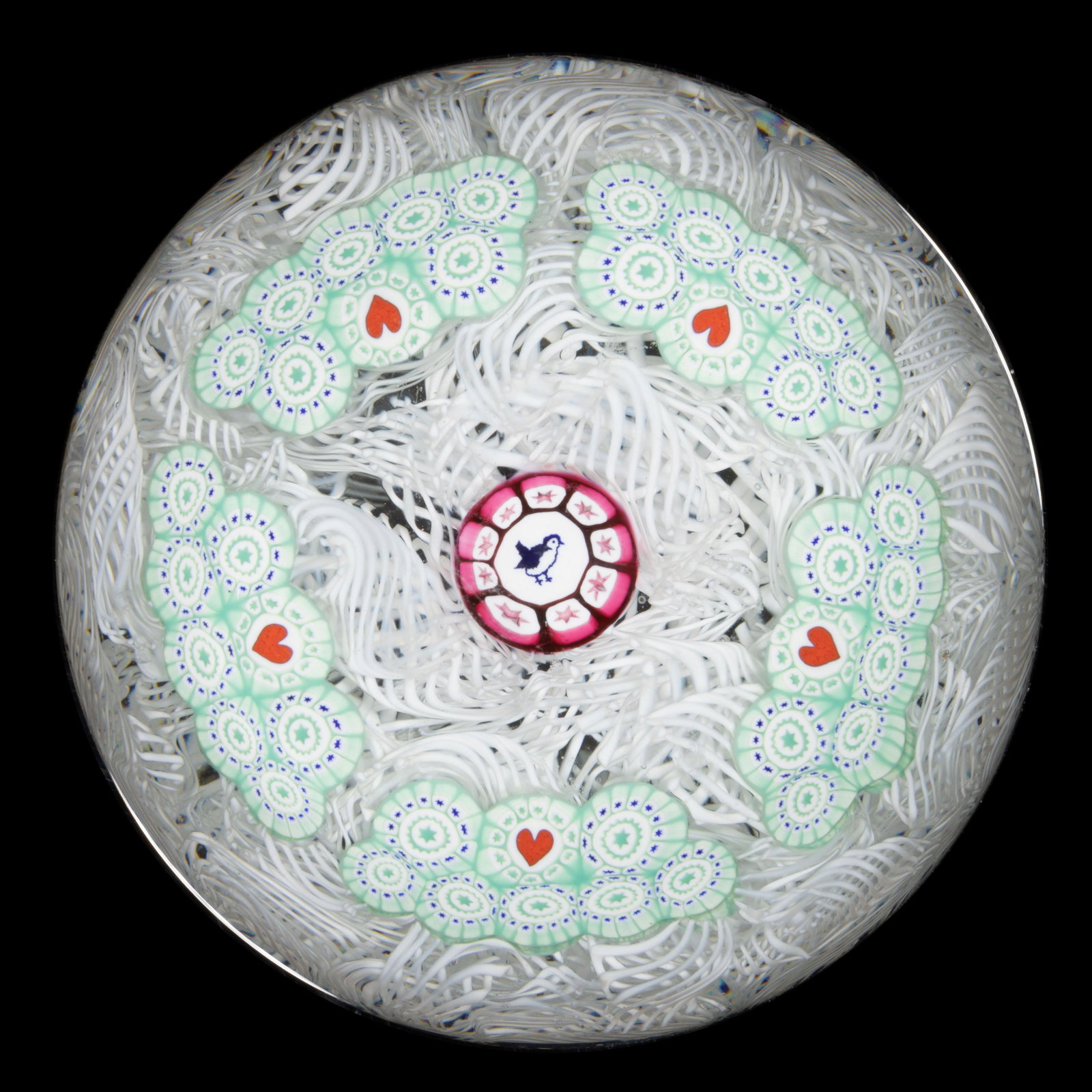 JOHN DEACONS (SCOTTISH, B. 1950) CONCENTRIC MILLEFIORI STUDIO ART GLASS PAPERWEIGHT, central: JOHN DEACONS (SCOTTISH, B. 1950) CONCENTRIC MILLEFIORI STUDIO ART GLASS PAPERWEIGHT, central silhouette cane featuring a bird with star tubes to the exterior, broken garland of five stacked wedges com