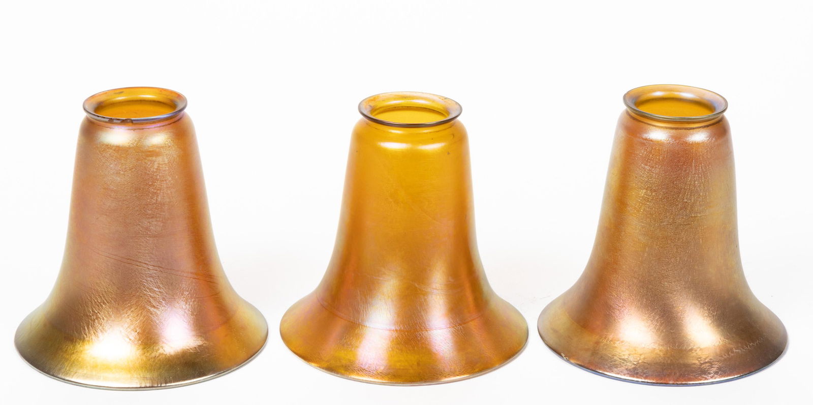 AMERICAN IRIDESCENT ART GLASS LAMP SHADES, LOT OF THREE, golden iridescent. Tiffany Studios.  (1 of 1)