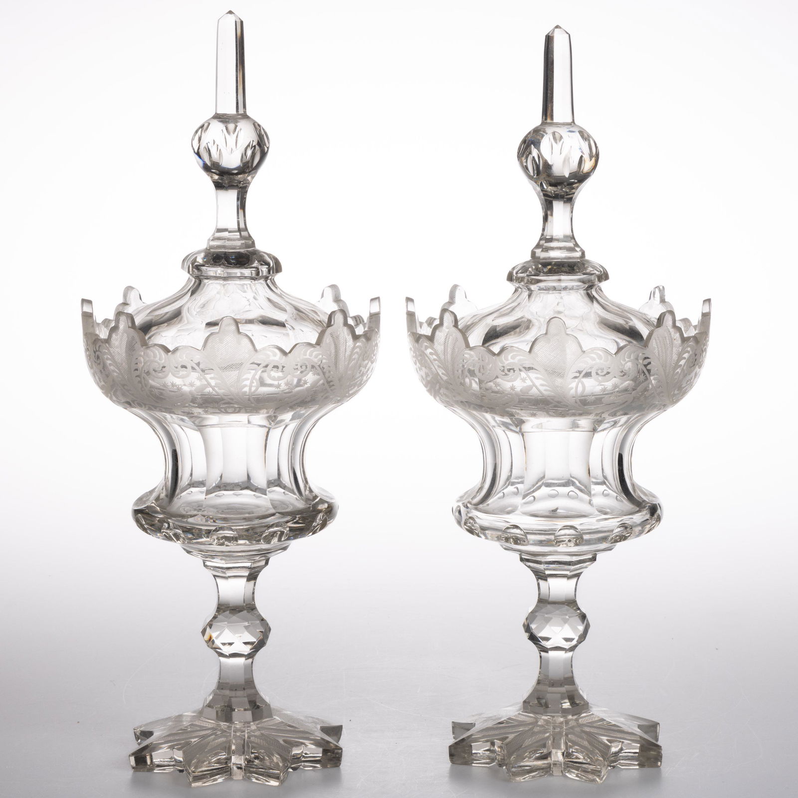 BOHEMIAN CUT AND ENGRAVED GLASS PAIR OF LARGE COVERED URNS, colorless, each having a large (1 of 1)