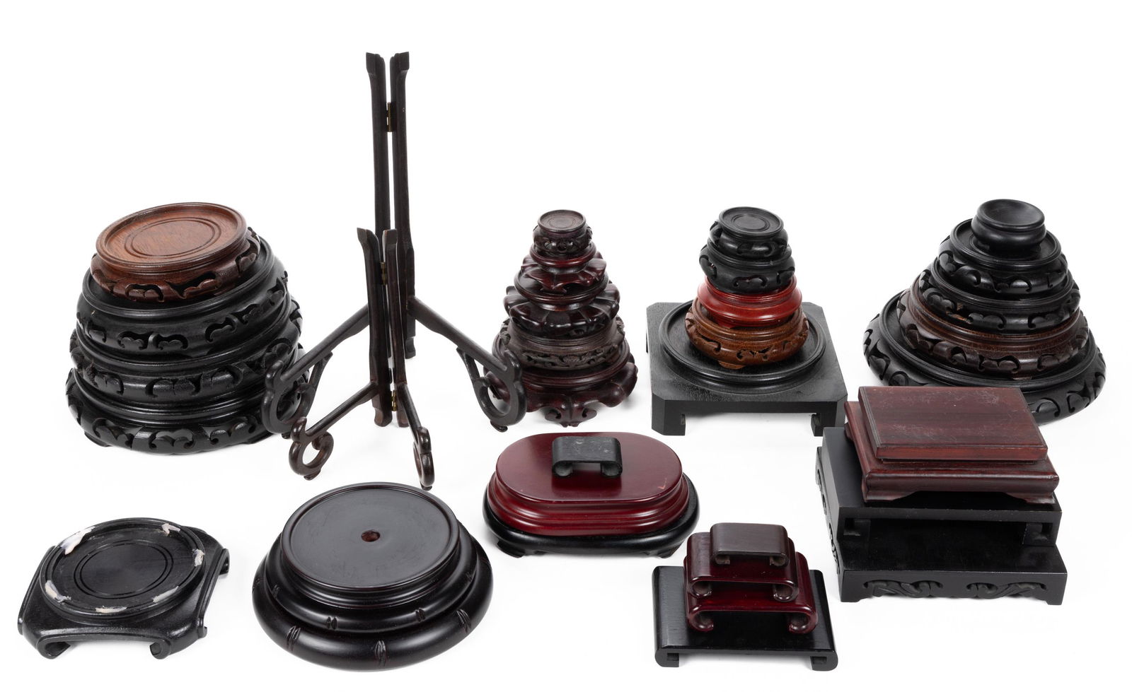 ASSORTED CHINESE CARVED TEAKWOOD AND OTHER STANDS, UNCOUNTED, each retains an old surface with warm: ASSORTED CHINESE CARVED TEAKWOOD AND OTHER STANDS, UNCOUNTED, each retains an old surface with warm color. Probably 20th century. Various sizes. From the Ann Connor C. Jones collection, Winston-S