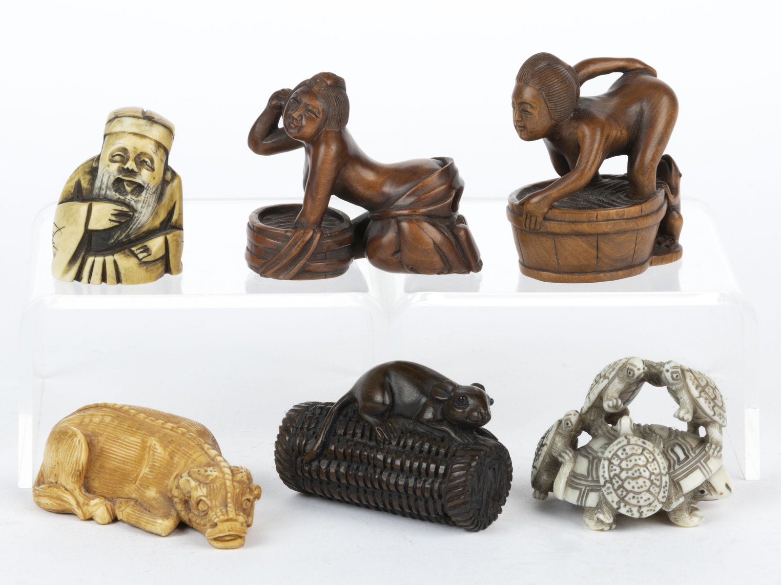 JAPANESE / CHINESE CARVED WOOD AND OTHER FIGURAL NETSUKE, LOT OF SIX, comprising a carved: JAPANESE / CHINESE CARVED WOOD AND OTHER FIGURAL NETSUKE, LOT OF SIX, comprising a carved wood rat on a cylindrical basket, two carved wood erotic examples with each featuring women kne