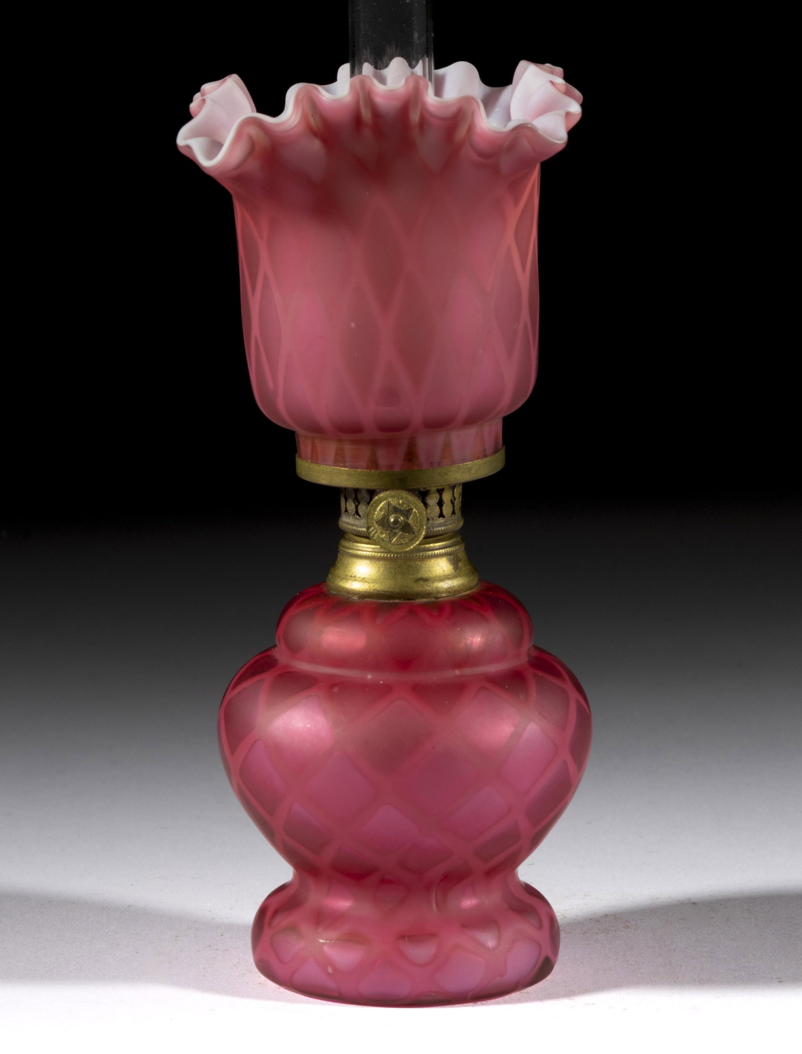 DIAMOND QUILT AIR-TRAP MOTHER-OF-PEARL SATIN MINIATURE LAMP: DIAMOND QUILT AIR-TRAP MOTHER-OF-PEARL SATIN MINIATURE LAMP, cased raspberry, ball-form font with foot and shoulder ring, matching patterned square-form shade with lightly flared and crimped rim,