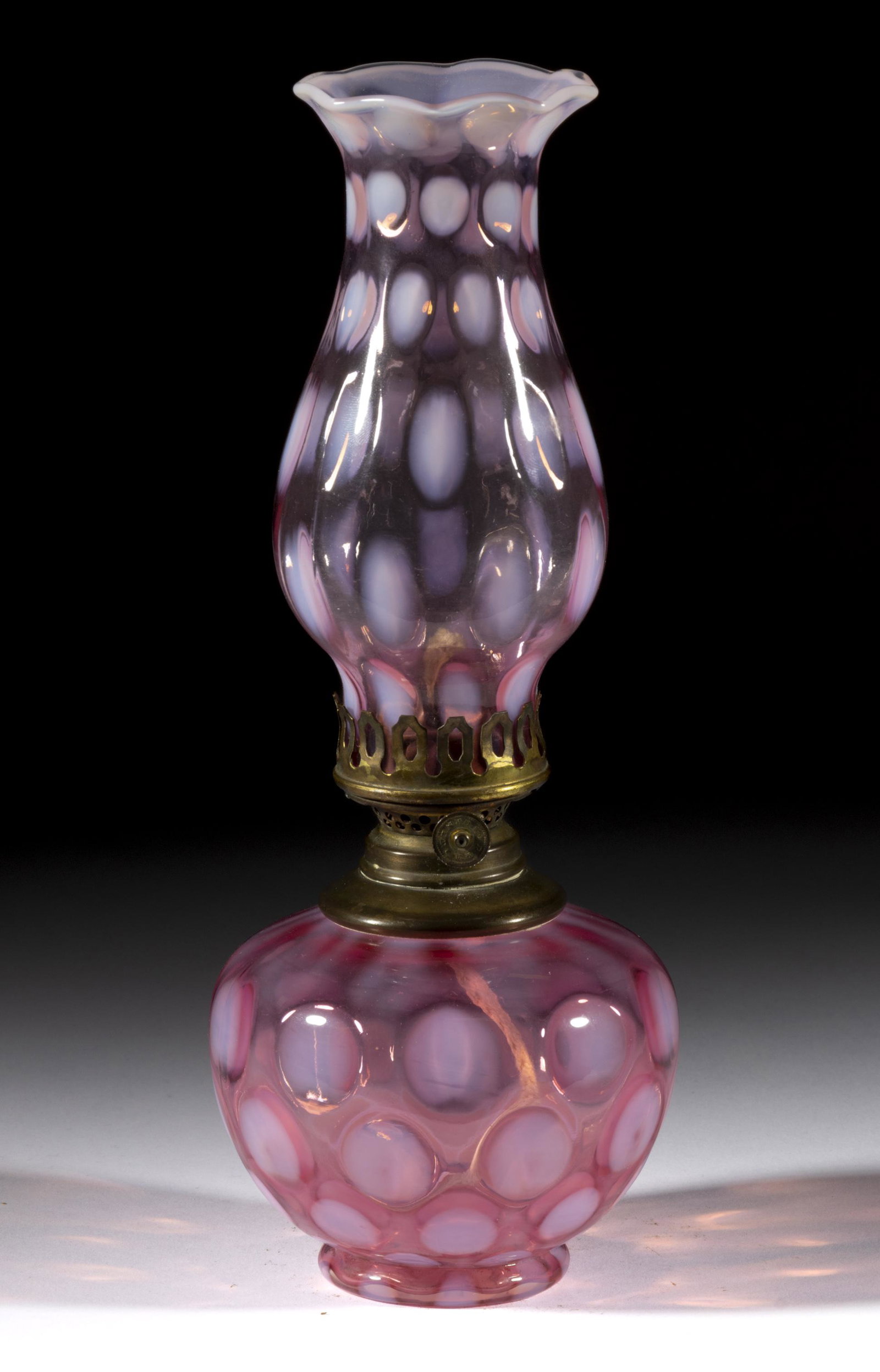 COINDOT MINIATURE LAMP: COINDOT MINIATURE LAMP, cranberry opalescent, slightly lighter cranberry opalescent and matching patterned chimney-shade, period brass collar with shoulder plate. Fitted with a Plume & Atwood Horn