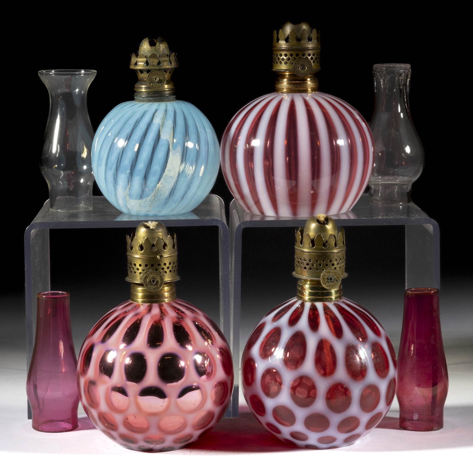 ASSORTED OPALESCENT GLASS MINIATURE LAMP FONTS, LOT OF FOUR: ASSORTED OPALESCENT GLASS MINIATURE LAMP FONTS, LOT OF FOUR, blue and cranberry opalescent, comprising two Stripe examples and two Windows examples, including a published Hulsebus II, fig. 71 exa