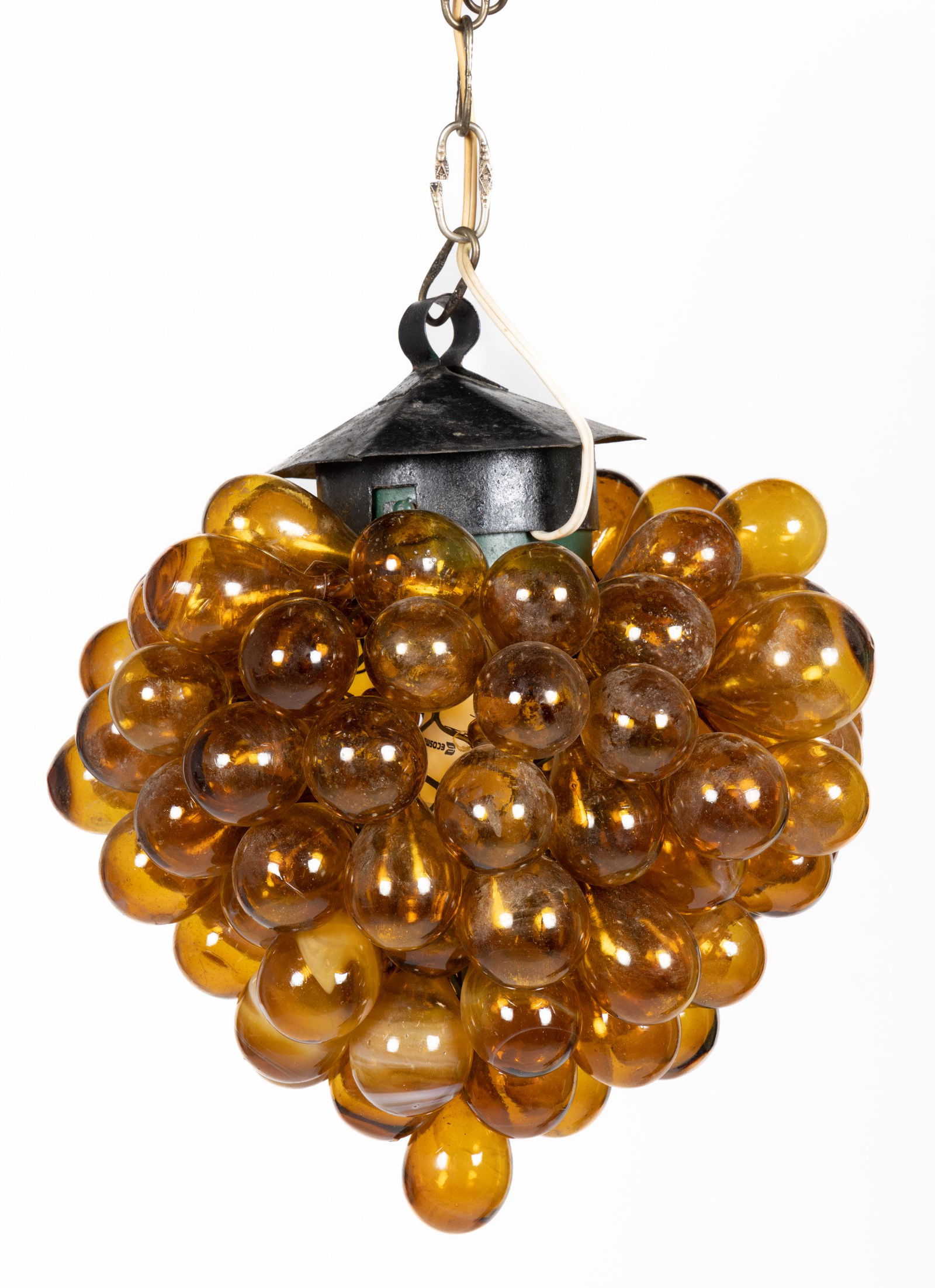 MODERN GRAPE CLUSTER FIGURAL ELECTRIC HANGING LAMP: MODERN GRAPE CLUSTER FIGURAL ELECTRIC HANGING LAMP, black hexagonal hanging cap supporting an interior wire frame holding many hand-blown amber bulbs creating the appearance of a grape cluster, some b