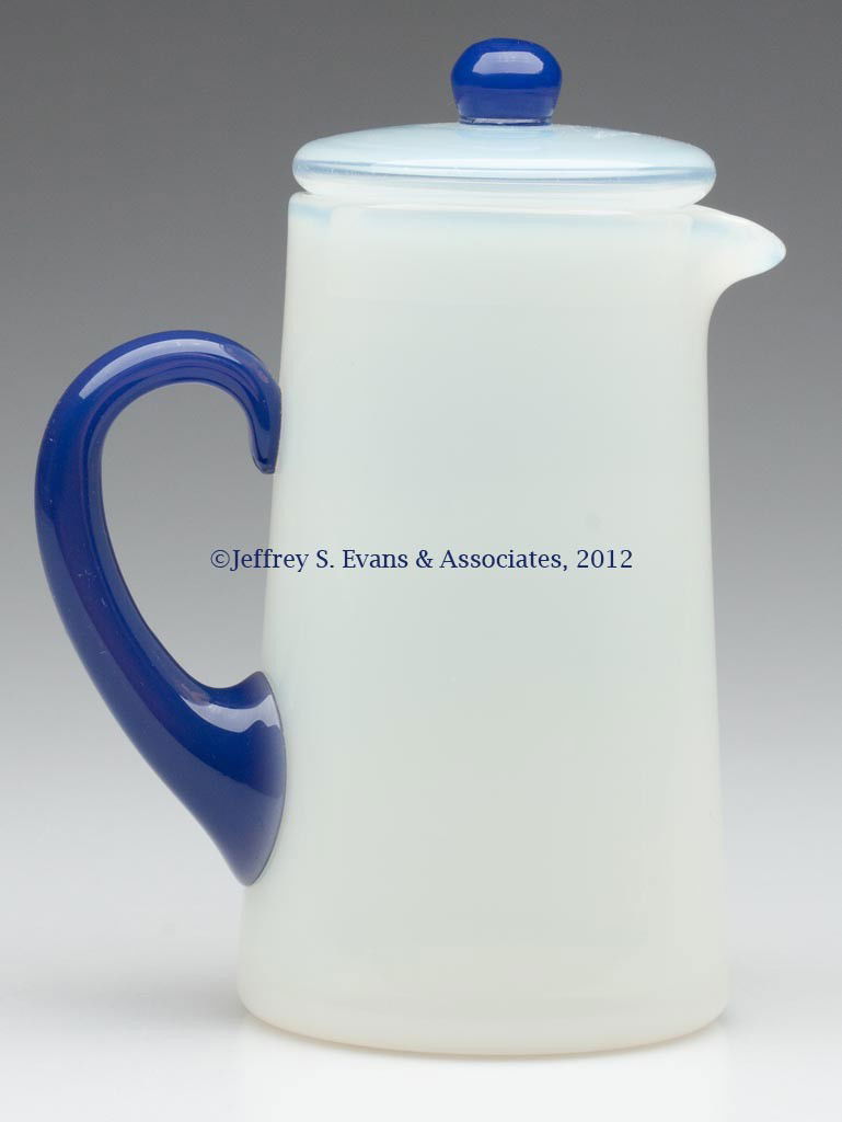 FRY ART GLASS #2000 HOT WATER JUG WITH COVER: FRY ART GLASS #2000 HOT WATER JUG WITH COVER, Foval Delft handle and finial, polished pontil mark. H. C. Fry Glass Co. First quarter 20th century. 6" HOA. Literature: Parallels The Collector's Encyclo