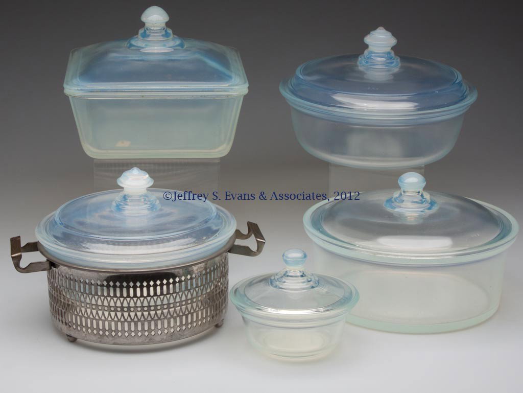 FRY KITCHENWARE COVERED DISHES, LOT OF FIVE: FRY KITCHENWARE COVERED DISHES, LOT OF FIVE, opalescent, #1922-8, #1935-7, #1938-4 1/2, #1938-7 with metal stand, and #1938-8. H. C. Fry Glass Co. First half 20th century. Provenance: Collection of Ja