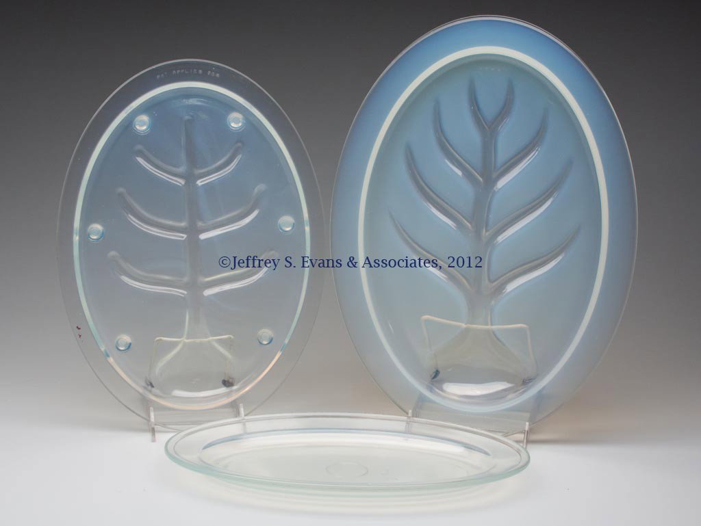 FRY KITCHENWARE PLATTERS, LOT OF THREE: FRY KITCHENWARE PLATTERS, LOT OF THREE, opalescent, #1958-11 and two tree-and-well, one raised on feet, larger marked W-8. H. C. Fry Glass Co. First half 20th century. 13 1/2" to 17 1/4" L. Provenance