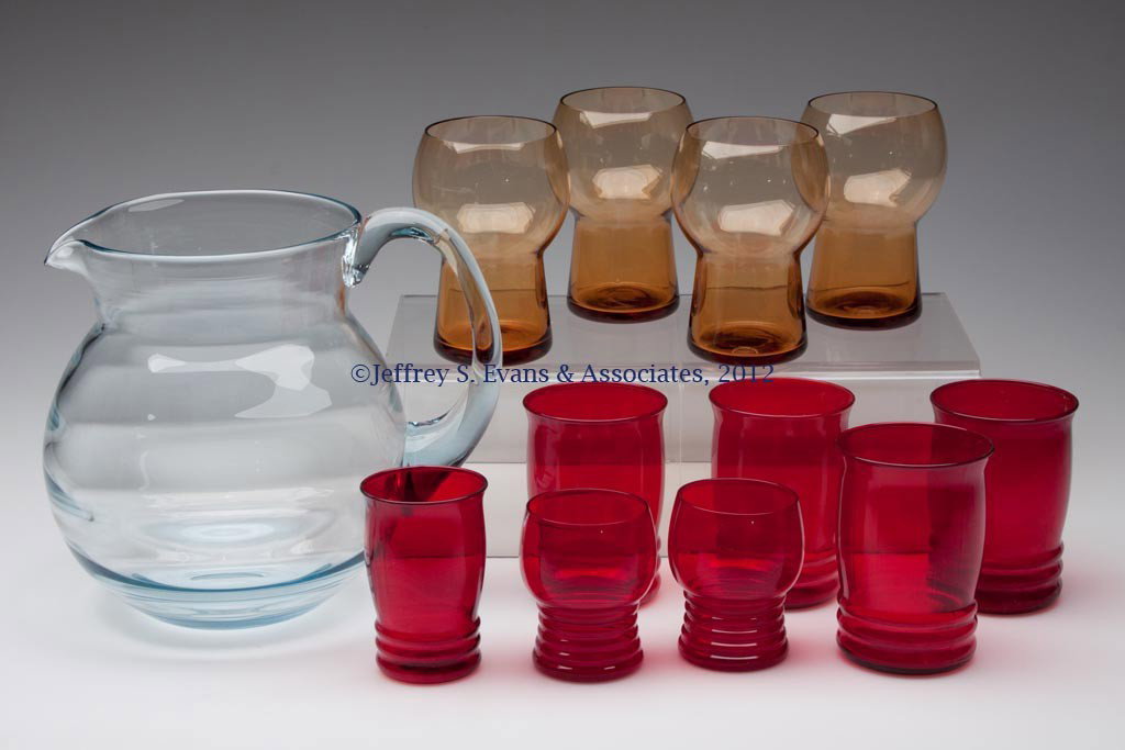 VARIOUS ELEGANT AND DEPRESSION BEVERAGE ARTICLES, : VARIOUS ELEGANT AND DEPRESSION BEVERAGE ARTICLES, LOT OF 12, amber, light blue and ruby, comprising a pitcher with applied handle and polished pontil mark, and eleven (11) various tumblers. First half