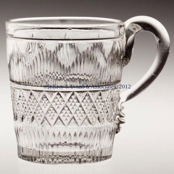 HAMILTON LEMONADE OR HANDLED TUMBLER: HAMILTON LEMONADE OR HANDLED TUMBLER, colorless lead glass, applied handle, polished pontil mark. Third quarter 19th century. 2 7/8" H, 2 1/2" D rim. Provenance: Jerry Lynn Wood estate, Dequincy, LA.
