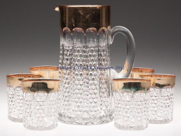 DUNCAN NO. 44 / BUTTON PANEL SEVEN-PIECE WATER SET: DUNCAN NO. 44 / BUTTON PANEL SEVEN-PIECE WATER SET, colorless with excellent gilt decoration, comprising a tankard water pitcher and six tumblers. Geo. Duncan & Sons. Late 19th/early 20th century. 9 1