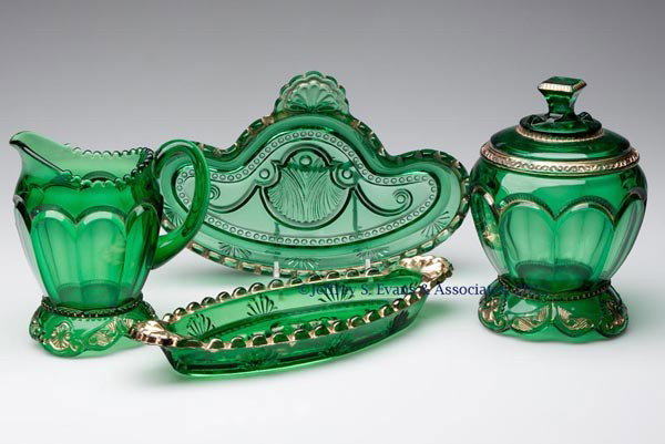 EMPRESS TABLE ARTICLES, LOT OF FOUR: EMPRESS TABLE ARTICLES, LOT OF FOUR, green with gilt decoration, comprising a covered sugar bowl, creamer, large cruet/spoon tray and pickle tray. Riverside Glass Works. Late 19th/early 20th century. 