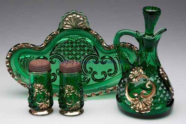 RIVERSIDE NO. 484 / CROESUS FOUR-PIECE CONDIMENT S: RIVERSIDE NO. 484 / CROESUS FOUR-PIECE CONDIMENT SET, green with gilt decoration, comprising a large cruet with original stopper, salt and pepper shakers with matching lids, and a large cruet/spoon tr