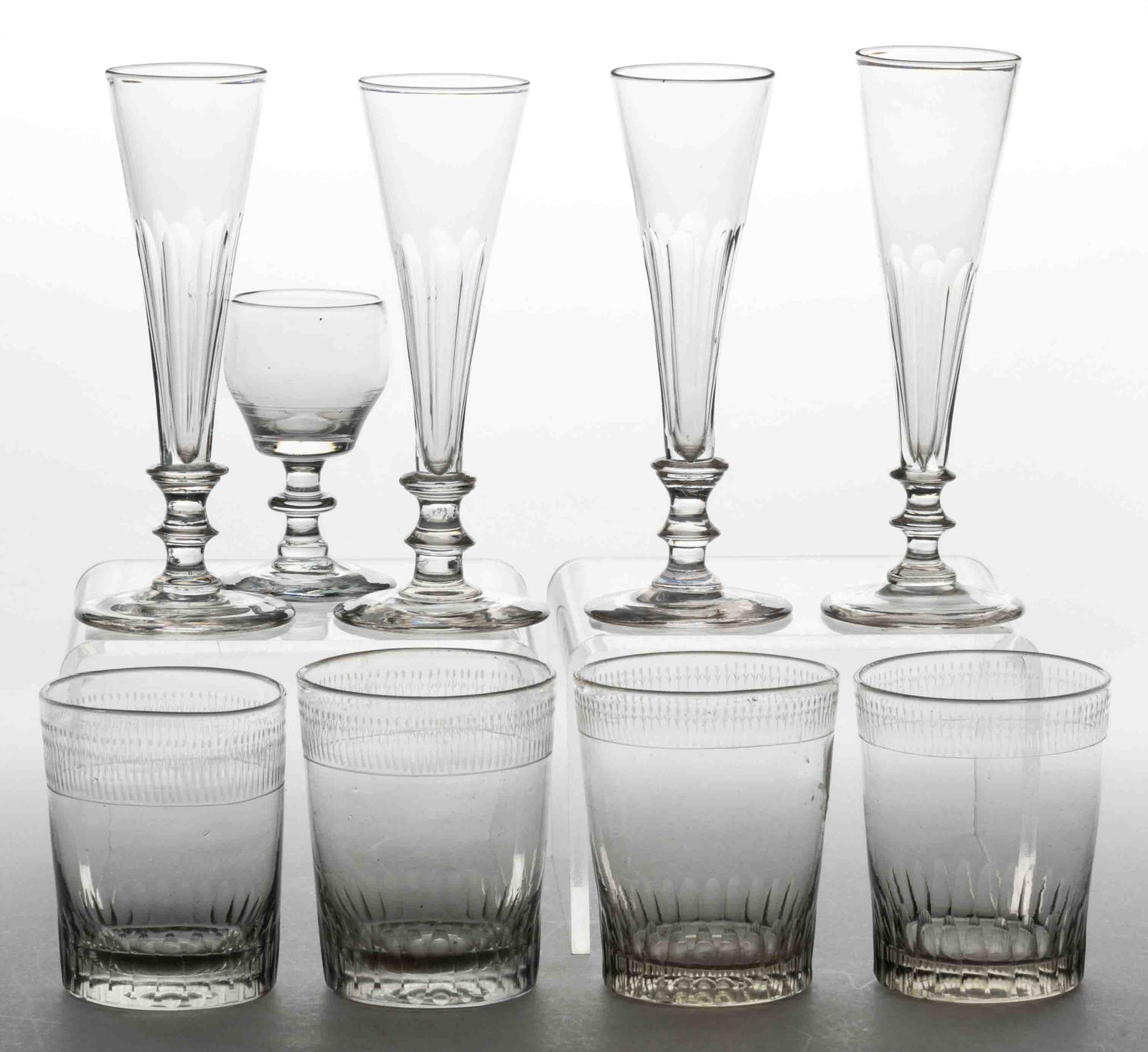 ASSORTED FREE-BLOWN AND ENGRAVED GLASS DRINKING ARTICLES, LOT OF NINE: ASSORTED FREE-BLOWN AND ENGRAVED GLASS DRINKING ARTICLES, LOT OF NINE, colorless, including four flute-cut trumpet wine glasses, and four tumblers with matching floral engraving near the rim. Various 