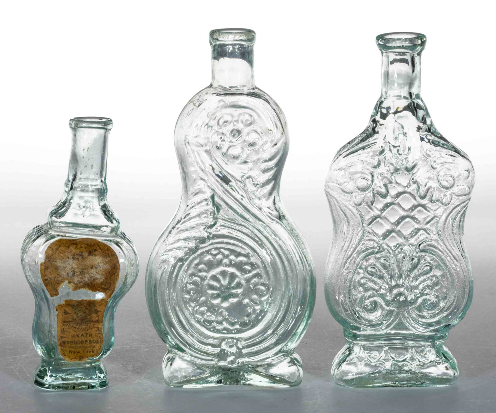 BLOWN-MOLDED FIGURED COMMERCIAL COLOGNE BOTTLES, LOT OF THREE (1 of 1)