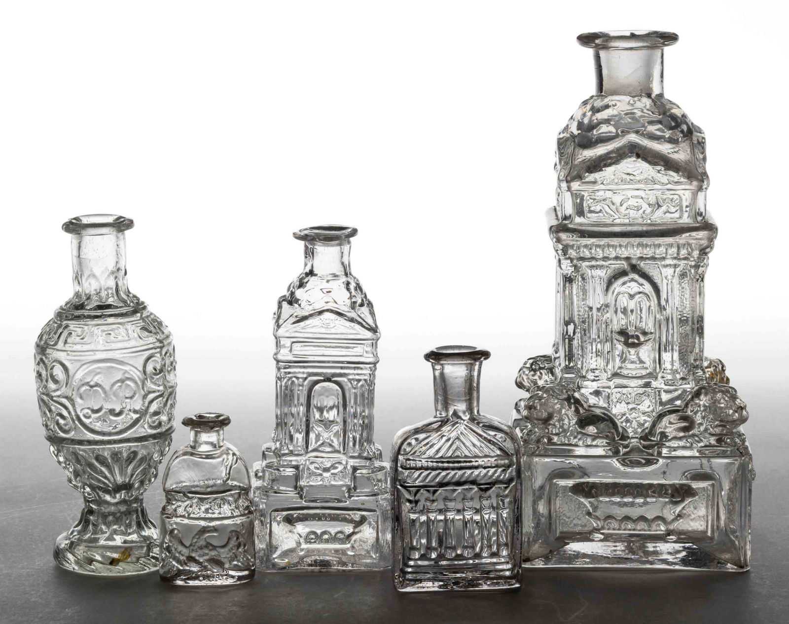 BLOWN-MOLDED FIGURED COMMERCIAL COLOGNE BOTTLES, LOT OF FIVE (1 of 1)