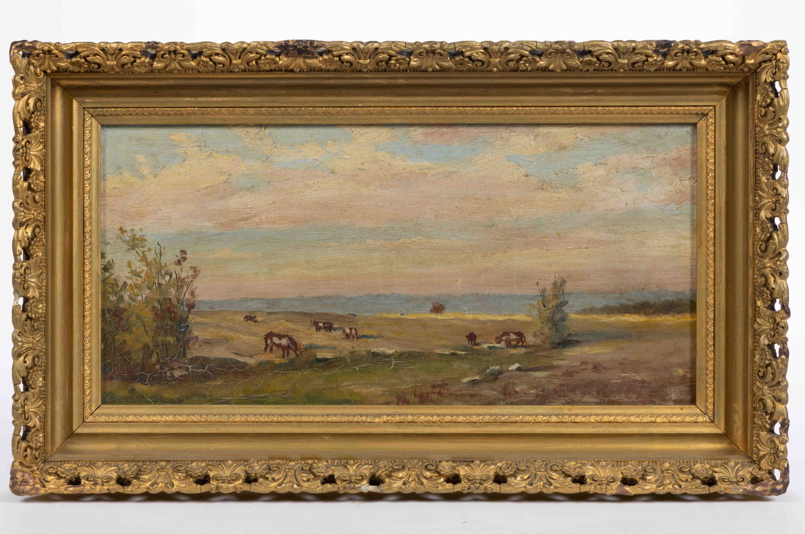 AMERICAN SCHOOL (LATE 19TH CENTURY) LANDSCAPE PAINTING WITH COWS: AMERICAN SCHOOL (LATE 19TH CENTURY) LANDSCAPE PAINTING WITH COWS, oil on canvas, depicting a grassy landscape with brown and white cows, a few trees, light blue mountains in the distance, all under a 